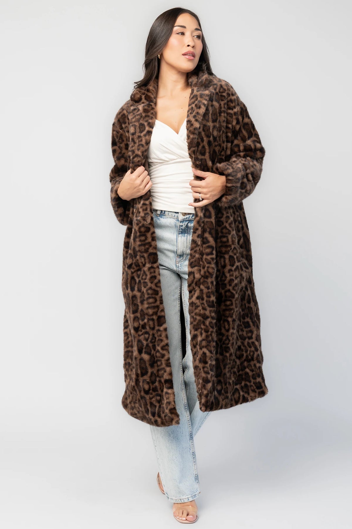 Novalie Coat in Brown Leopard Print with plush faux fur texture, notched collar, long sleeves, and longline silhouette.