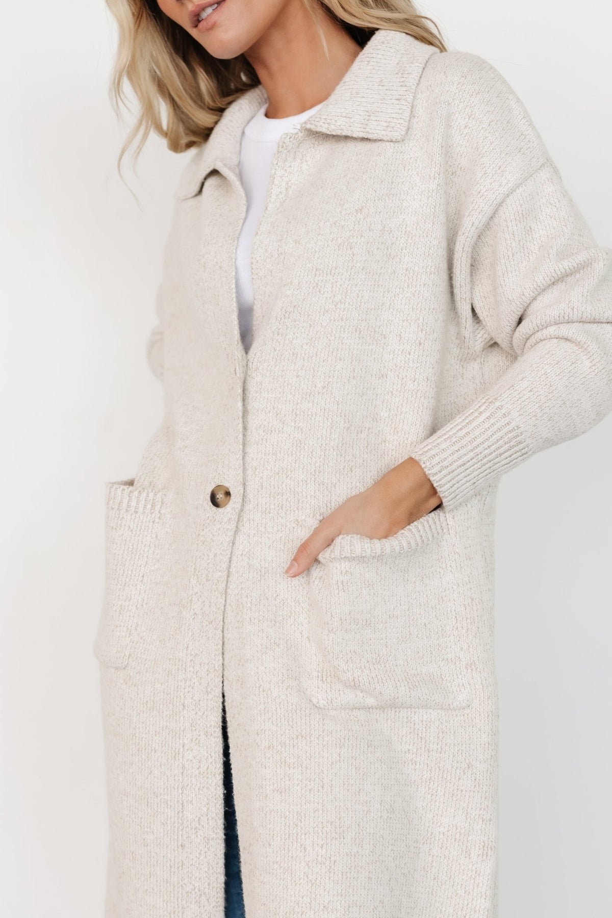 Styled outfit view showing oatmeal longline cardigan layered over casual separates for a cozy transitional-season ensemble.
