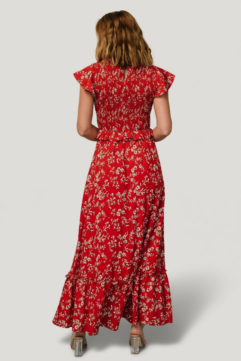 Fabric and print close-up showing delicate white and brown florals on rich red chiffon material with lining peek.