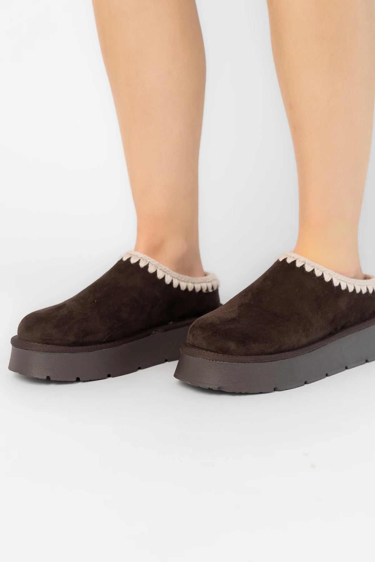 Pamela Platform Cozy Mule Slippers in Chocolate with faux suede, plush lining, whipstitch trim, and platform sole.