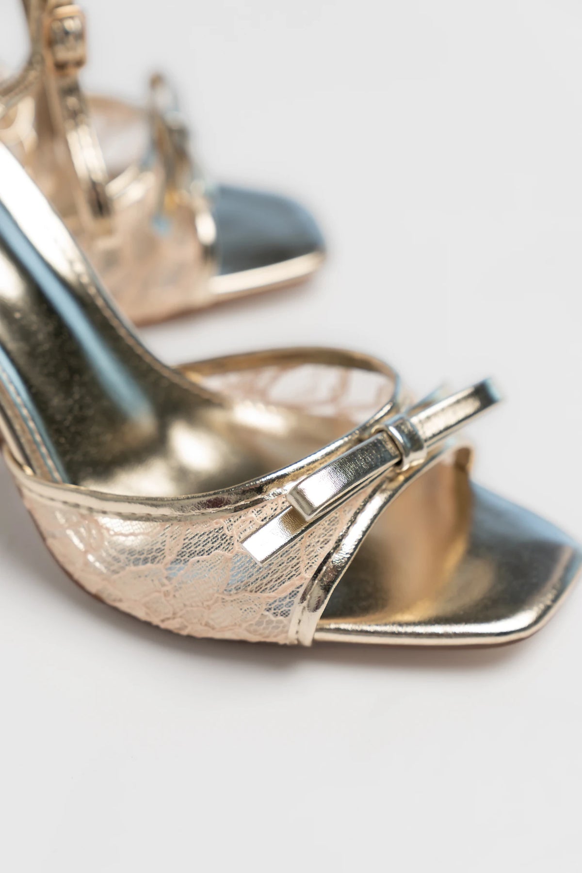 Passion Ankle Strap Heel in Gold with shimmering finish, bow detail at the toe, adjustable ankle strap, and stiletto heel.