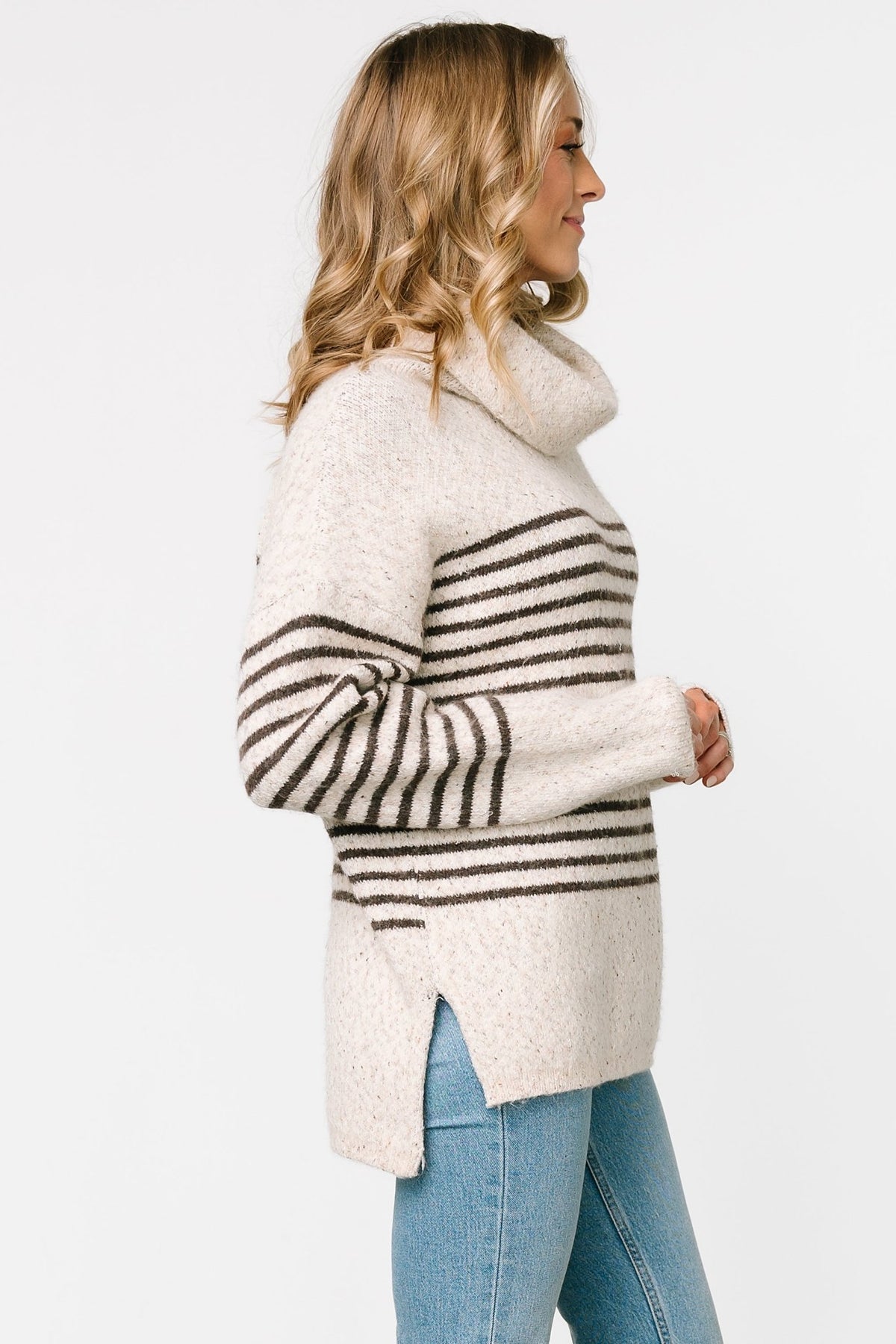 Front model view of Pennington turtleneck sweater in speckled cream with dark multi-stripes, ribbed cuffs and split side hem.