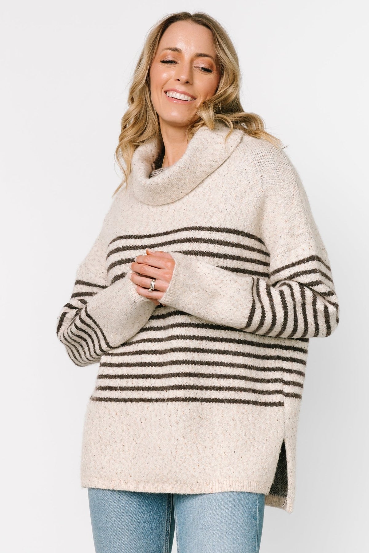 Front model view of Pennington turtleneck sweater in speckled cream with dark multi-stripes, ribbed cuffs and split side hem.