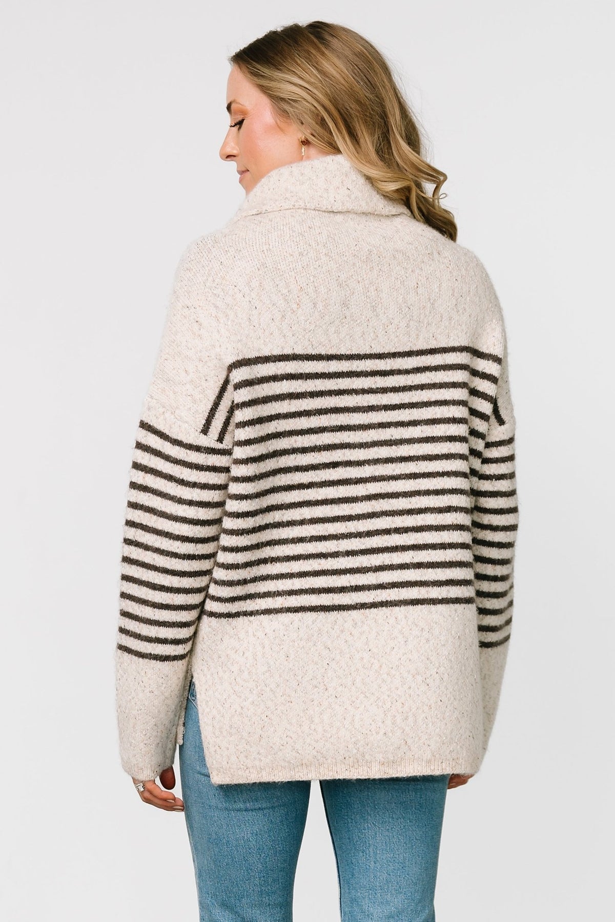 Front model view of Pennington turtleneck sweater in speckled cream with dark multi-stripes, ribbed cuffs and split side hem.