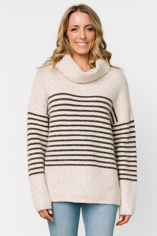 Front model view of Pennington turtleneck sweater in speckled cream with dark multi-stripes, ribbed cuffs and split side hem.