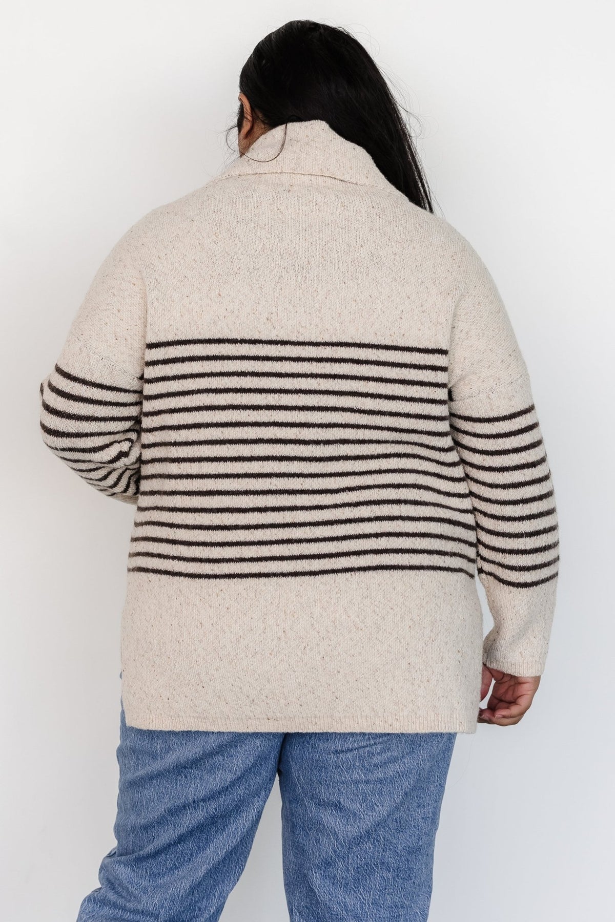 Front model view of Pennington turtleneck sweater in speckled cream with dark multi-stripes, ribbed cuffs and split side hem.