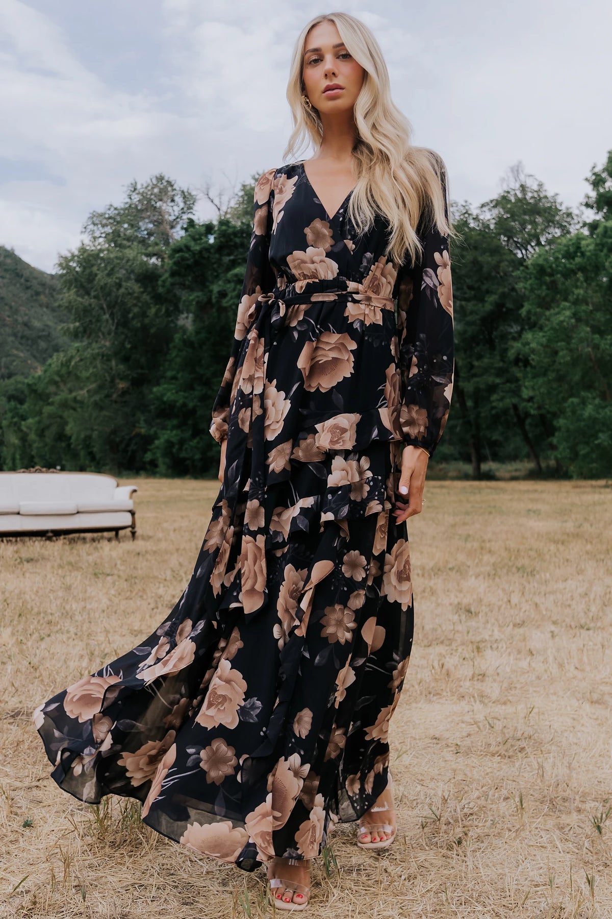 Phaedra Maxi Dress in Black + Taupe Floral with surplice V-neck, long sleeves, sash waist, and tiered skirt.