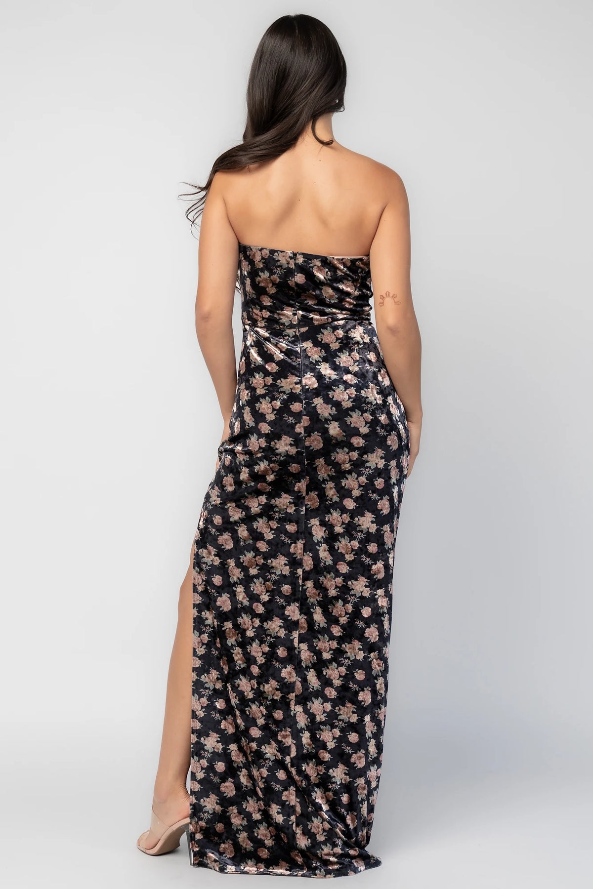 Philippa Velvet Maxi Dress in Black Floral with strapless neckline, floral velvet fabric, side ruching, and thigh-high slit.