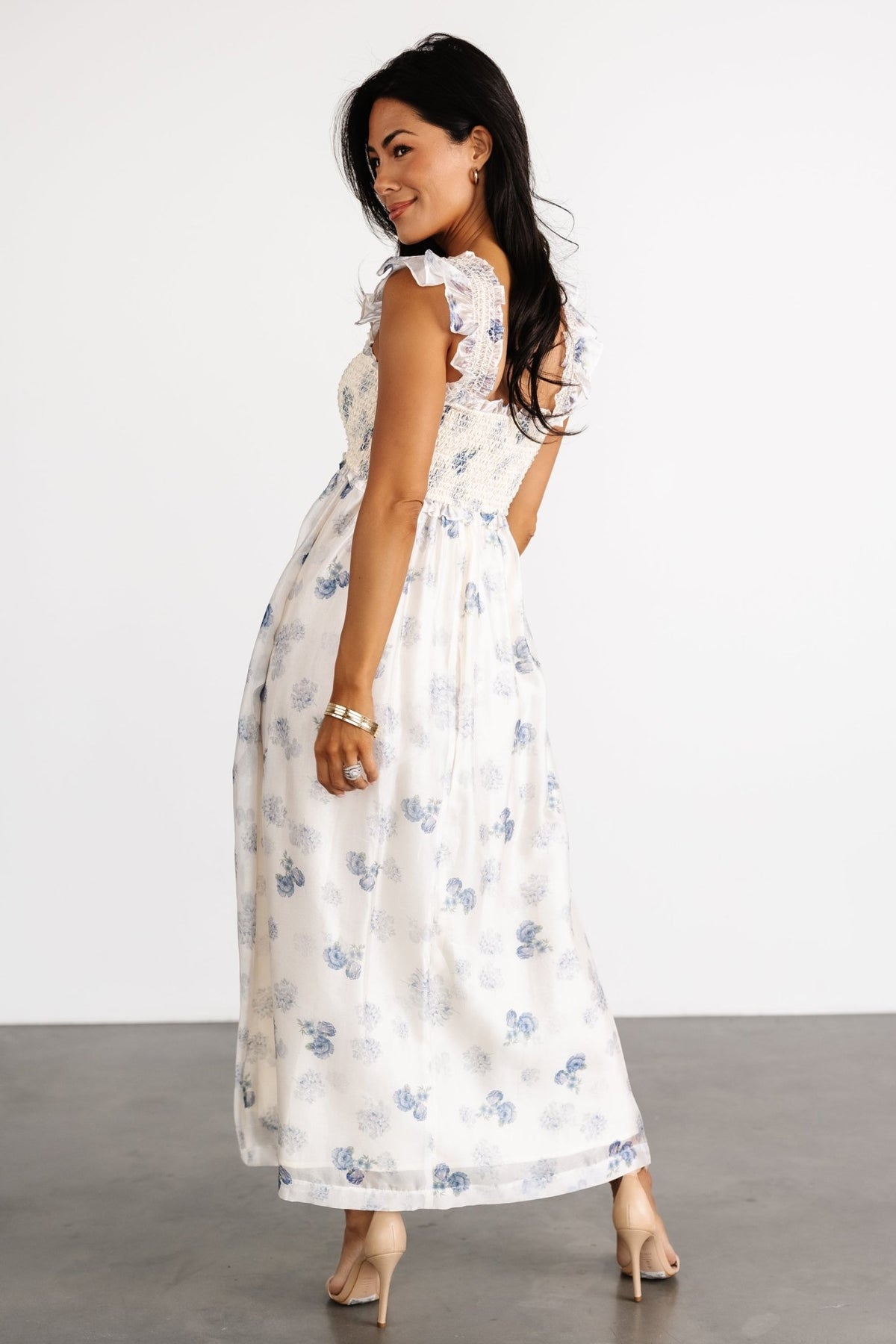 Fabric close-up showing the silky organza texture, blue floral motif on cream base, and the dress’s lightweight, airy weave.