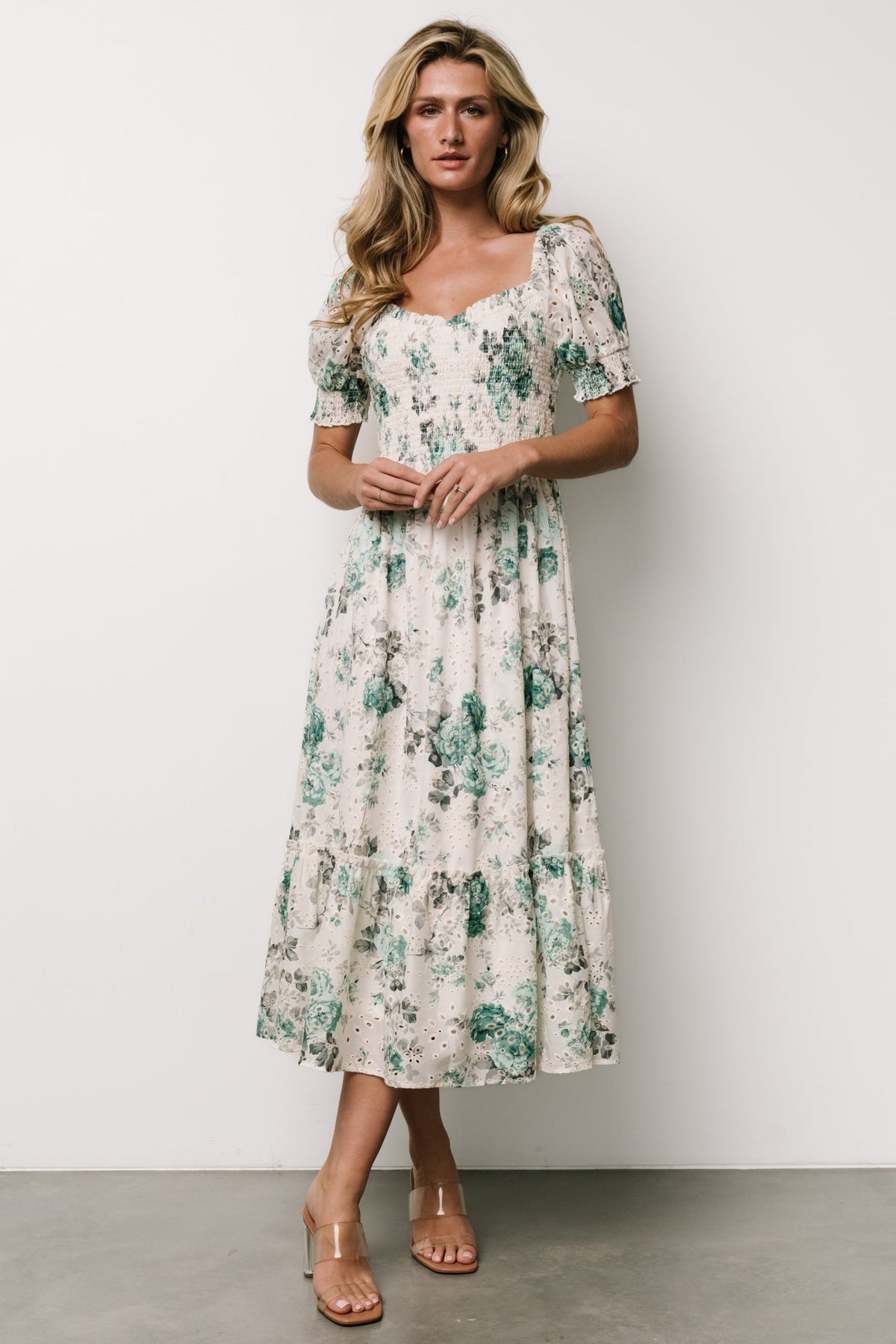 Three-quarter model shot of Piper Eyelet Midi Dress showing raglan puff sleeves, smocked cuffs and natural-high waist.