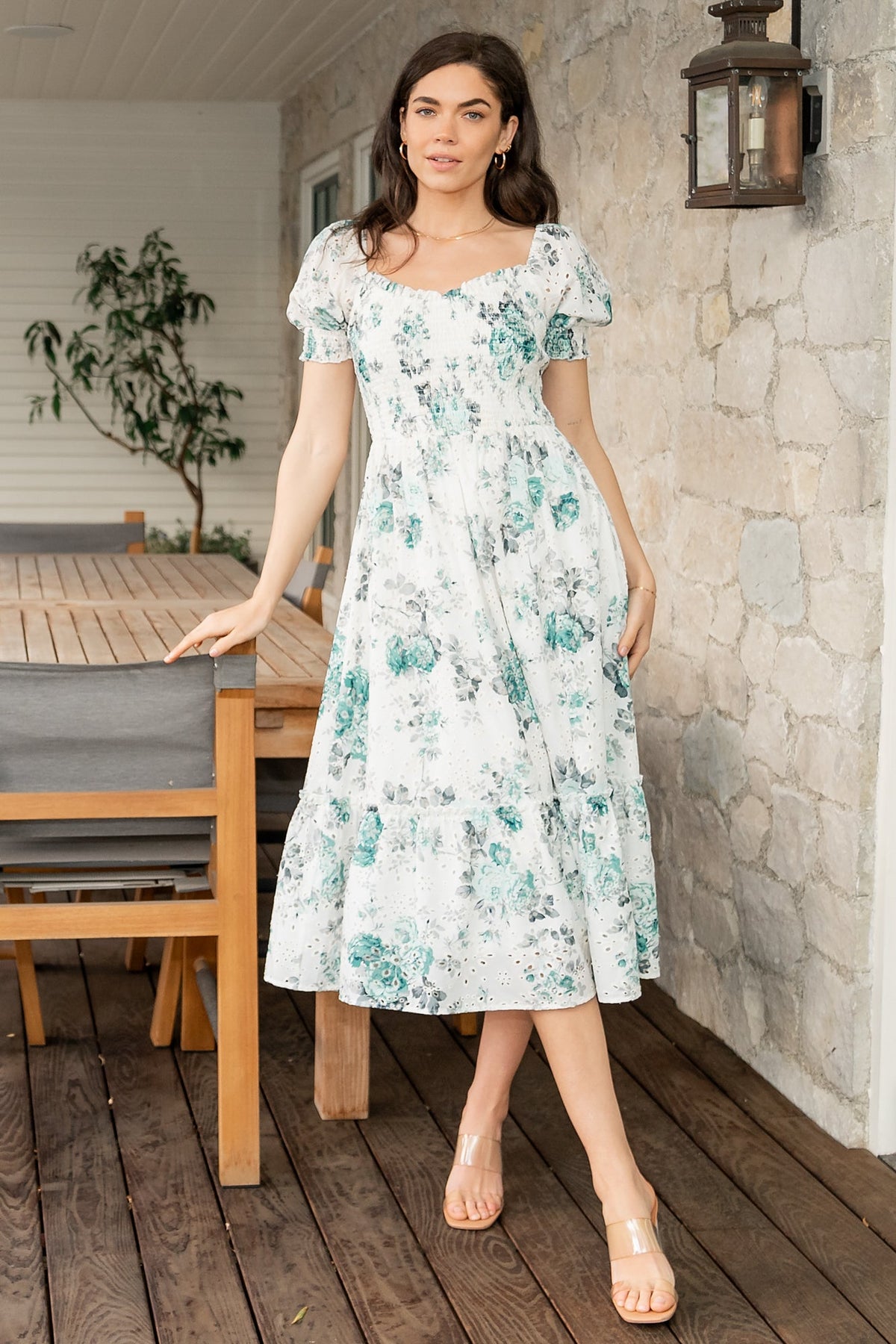 Full-length studio image of Piper Eyelet Midi Dress in off-white with green floral print, styled with neutral sandals.