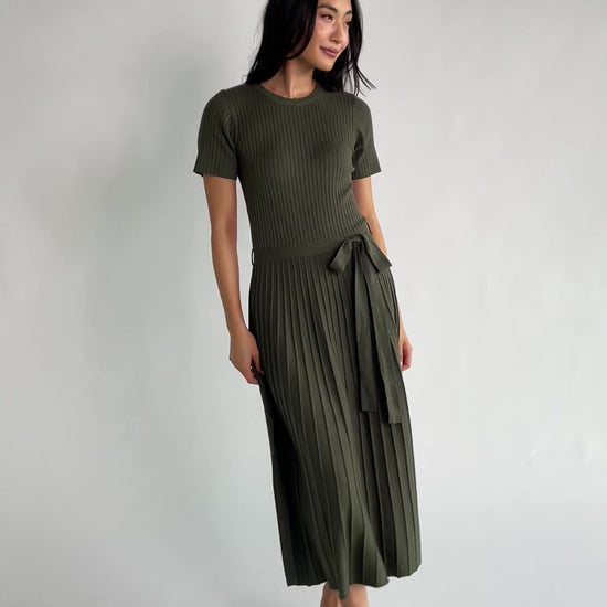 Jessamine Midi Dress with ribbed sweater knit, crew neckline, short sleeves, self-tie waist belt, and pleated skirt.