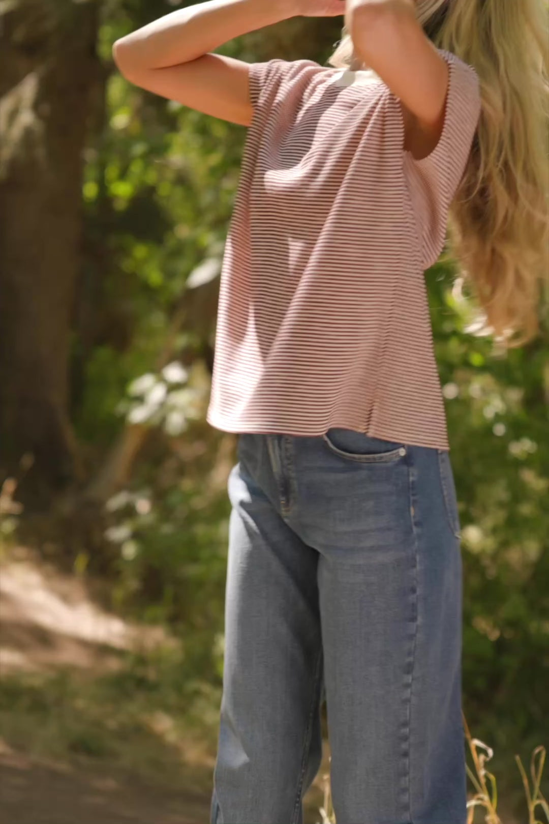 Bria High Rise Wide Leg Jeans in Medium Wash with relaxed wide legs, front and back pockets, button closure, and raw hem.