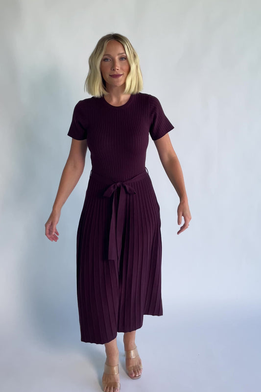 Jessamine Midi Dress in Dark Plum with a ribbed sweater knit, crew neckline, waist belt, and pleated midi skirt.