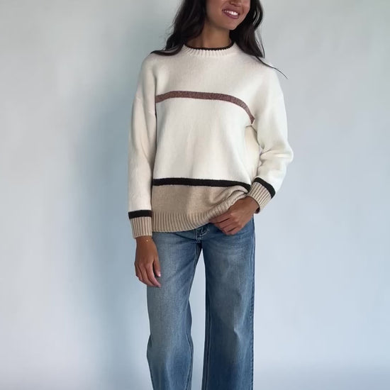 Natural color-block sweater with horizontal tan and brown stripes, a round neckline, long sleeves, and a relaxed fit.