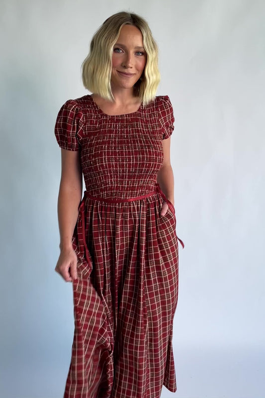 Lorelei Smocked Dress in Red Print with round neckline, smocked bodice, and elastic sleeves.