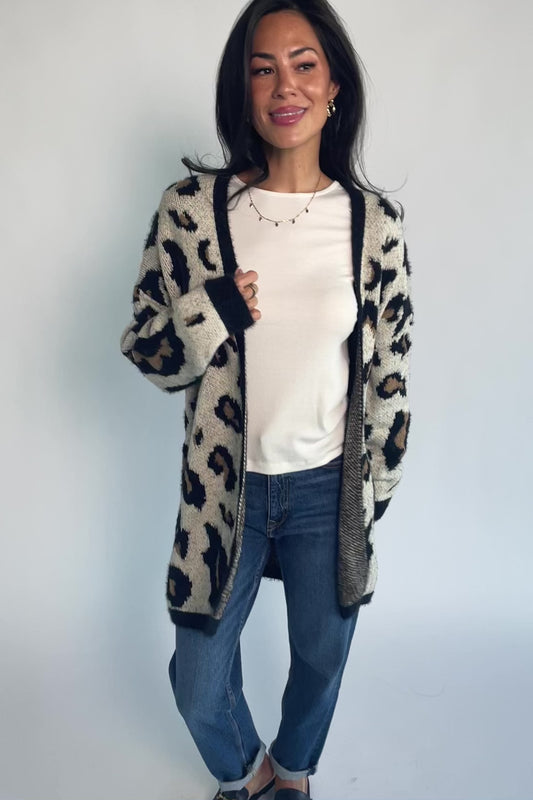 Model wearing the Jeter Open Cardigan in Leopard Print featuring a neutral knit with black and camel leopard print.
