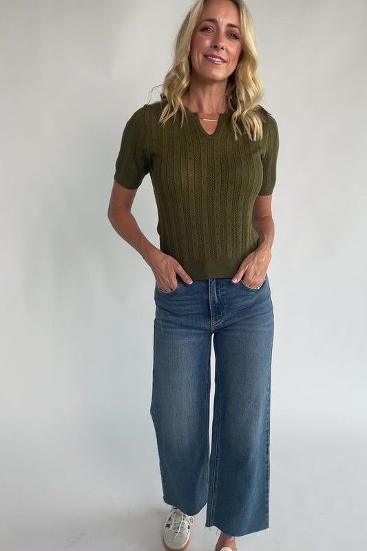 Pointelle knit top with a crew neckline, notch detail, short sleeves, and ribbed cuffs and hem.