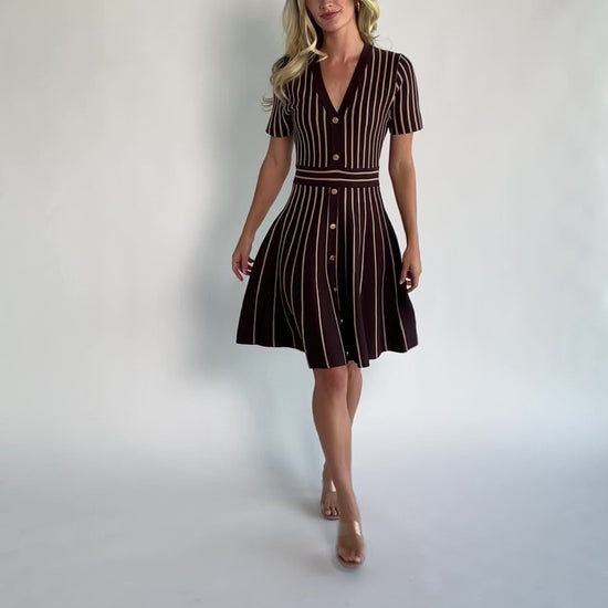 Model wearing the Tate Striped Short Dress in Brown + Beige featuring a soft sweater knit with beige vertical stripes.