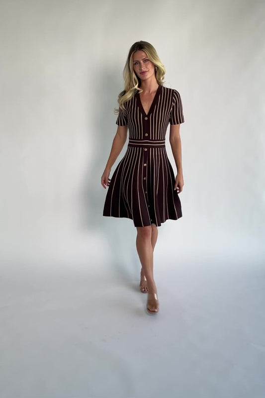 Model wearing the Tate Striped Short Dress in Brown + Beige featuring a soft sweater knit with beige vertical stripes.