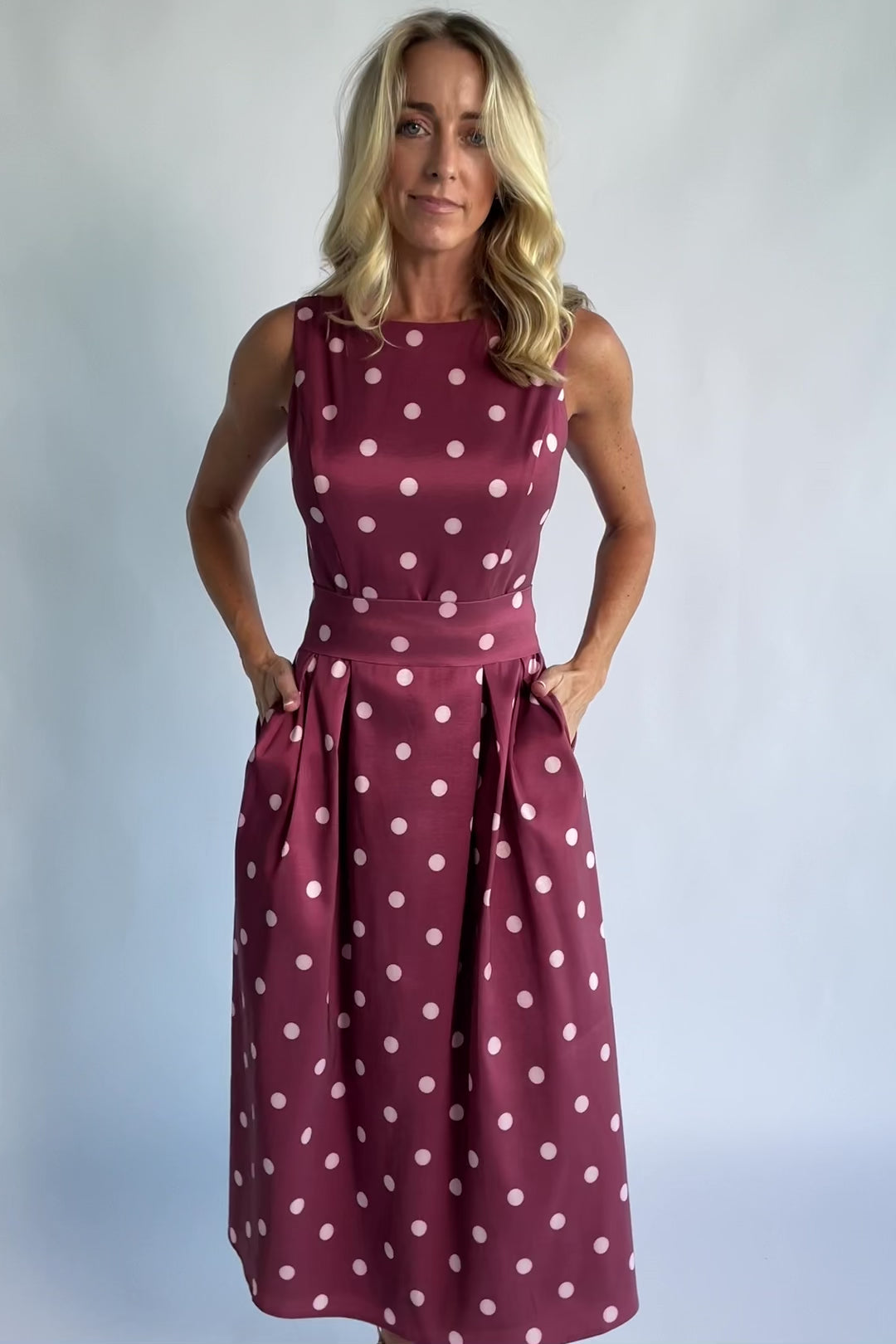 Chiara Midi Dress in Wine + Pink Dot with a boat neckline, pleated full skirt, and a fitted sleeveless bodice.