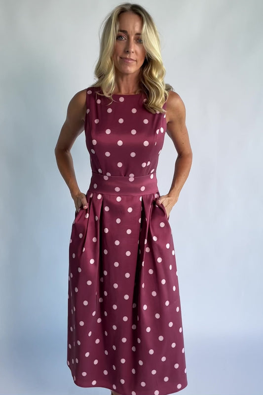 Chiara Midi Dress in Wine + Pink Dot with a boat neckline, pleated full skirt, and a fitted sleeveless bodice.