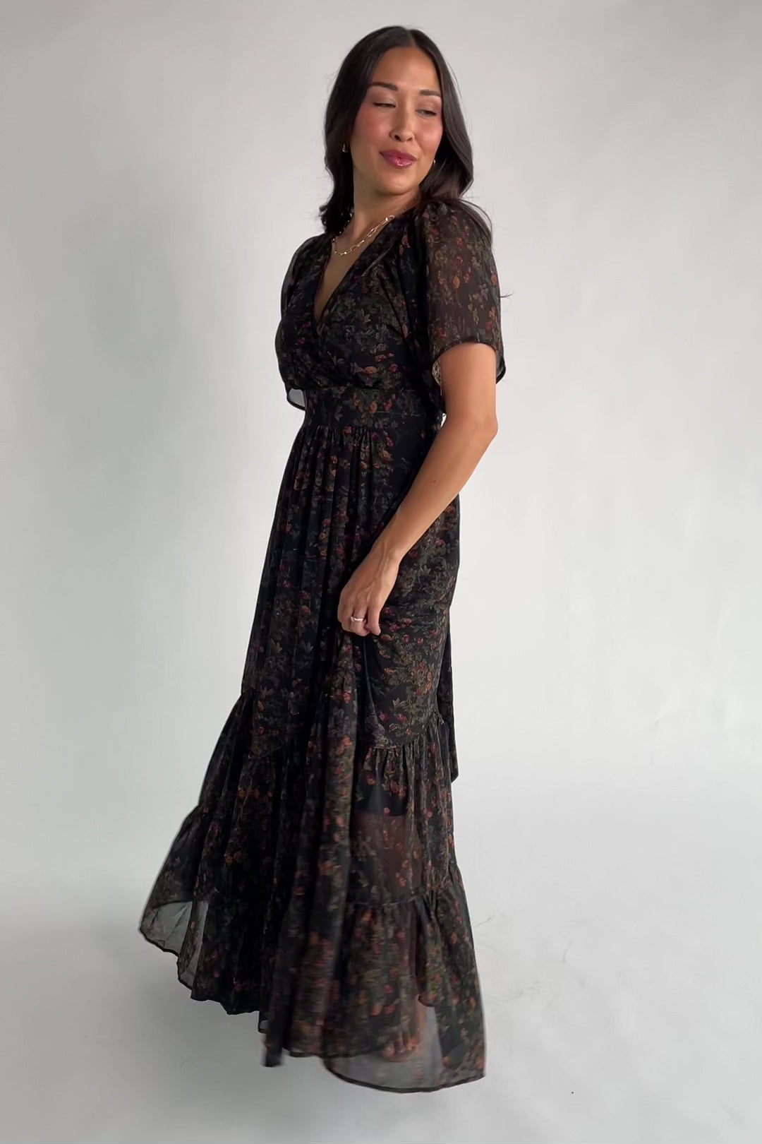 Katherine Maxi Dress in Black Multi Print with surplice V-neck, flutter sleeves, adjustable waist ties, and tiered skirt.