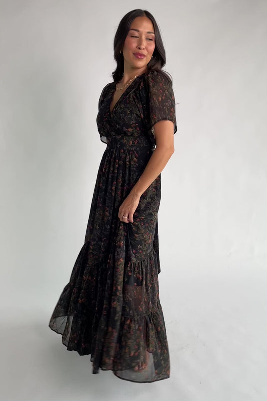 Katherine Maxi Dress in Black Multi Print with surplice V-neck, flutter sleeves, adjustable waist ties, and tiered skirt.