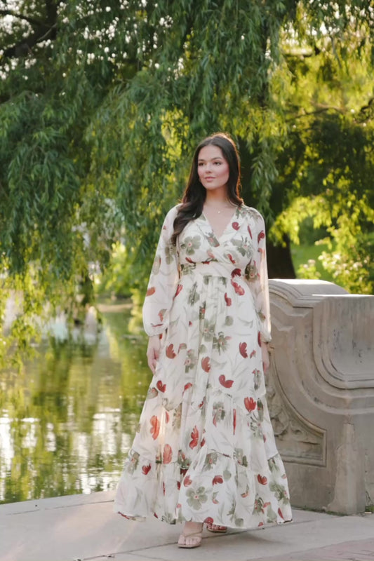 Cream Floral Chiffon Maxi Dress with rust and green florals, surplice neckline, long sleeves, waist ties, and tiered skirt.