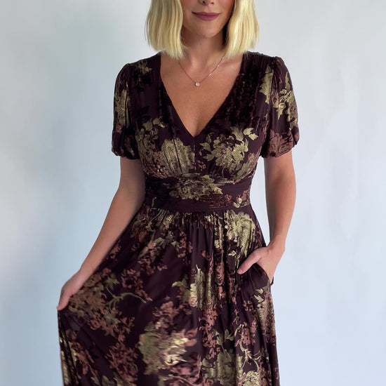 Leslie Velvet Maxi Dress in Brown + Metallic Gold with an embossed velvet floral design, a V-neckline, and puff sleeves.