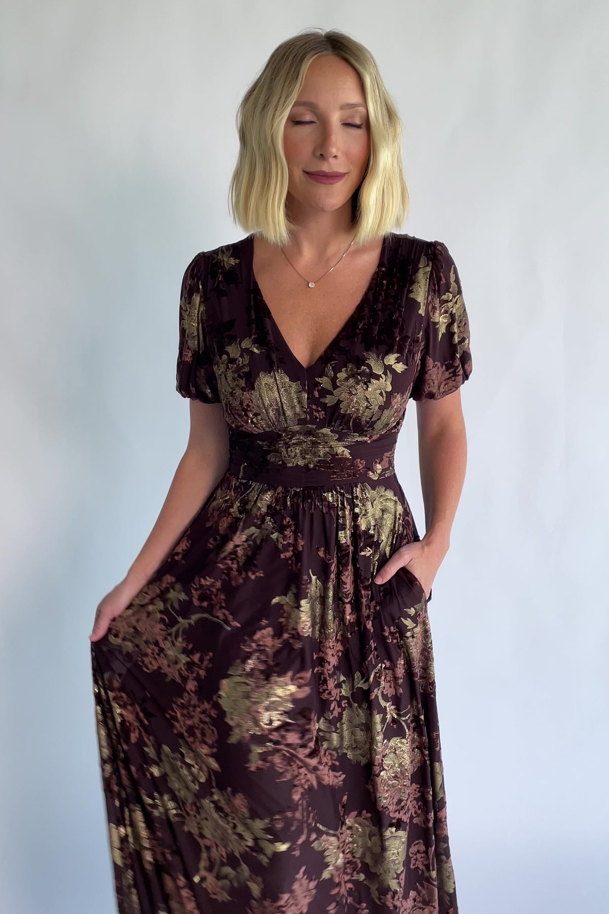 Leslie Velvet Maxi Dress in Brown + Metallic Gold with an embossed velvet floral design, a V-neckline, and puff sleeves.
