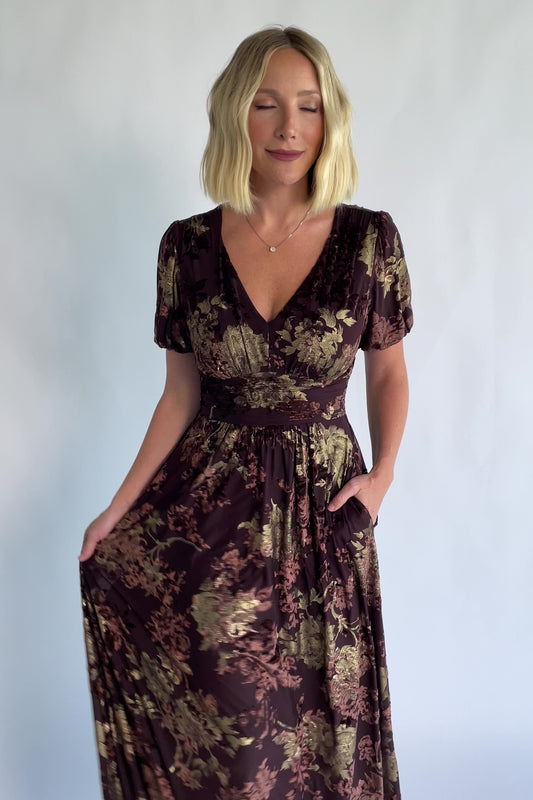 Leslie Velvet Maxi Dress in Brown + Metallic Gold with an embossed velvet floral design, a V-neckline, and puff sleeves.