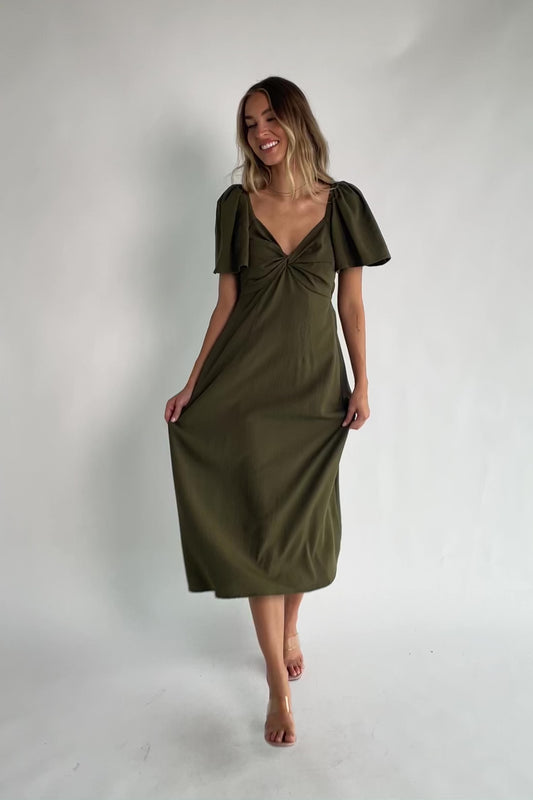 Indie Back Tie Dress in Olive with sweetheart neckline, butterfly sleeves, open tie-back, and side pockets.