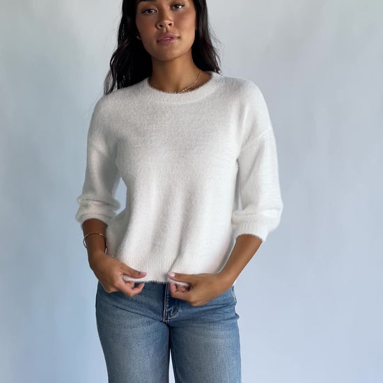 Calista Sweater Top in Off White with a round neckline, dropped shoulders, and 3/4-length sleeves.