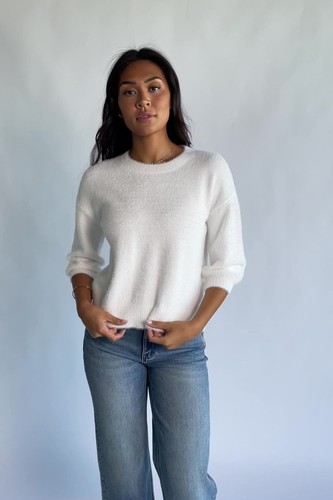 Calista Sweater Top in Off White with a round neckline, dropped shoulders, and 3/4-length sleeves.