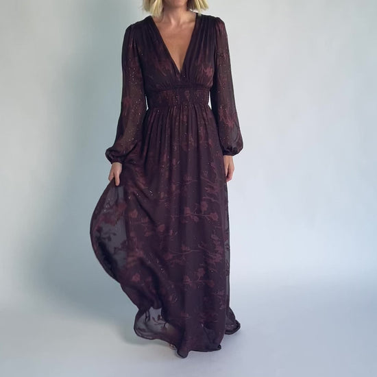 Jennifer Maxi Dress in Dark Mahogany with plunging V-neck, sheer long sleeves, gold sparkle, and textured florals.