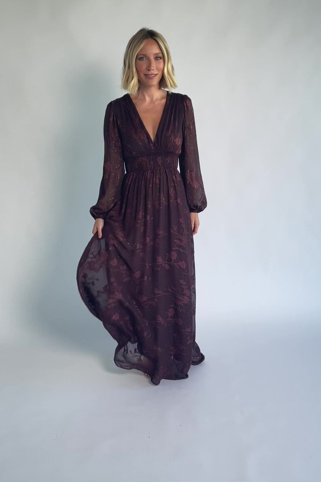 Jennifer Maxi Dress in Dark Mahogany with plunging V-neck, sheer long sleeves, gold sparkle, and textured florals.