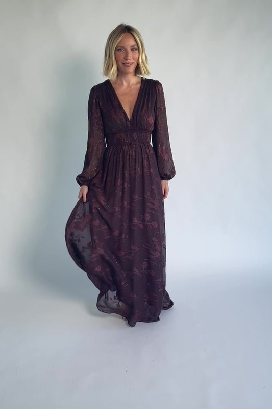 Jennifer Maxi Dress in Dark Mahogany with plunging V-neck, sheer long sleeves, gold sparkle, and textured florals.