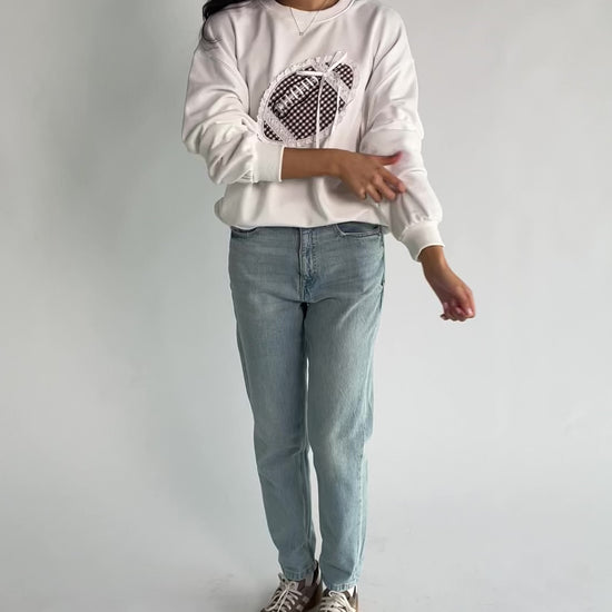 Stephen Gingham Crewneck in Ivory with brown gingham lace appliqué, ribbon bow detail, long sleeves, and ribbed trim.
