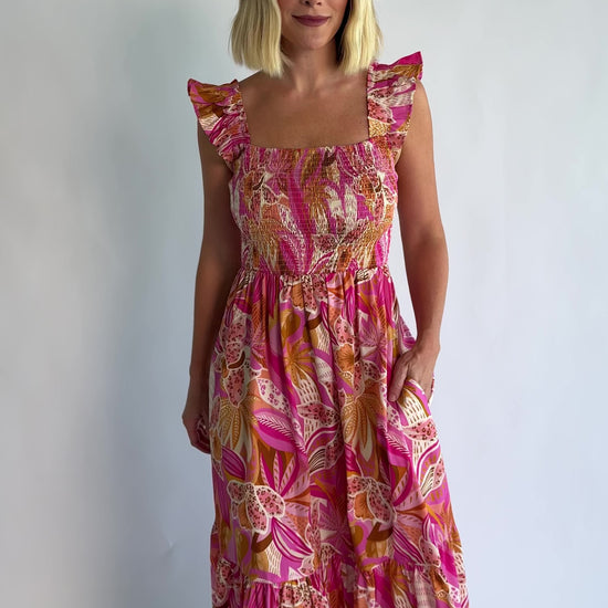 Carla Smocked Dress in Pink Multi with a smocked bodice, square neckline, ruffle straps, and a flowy midi skirt.