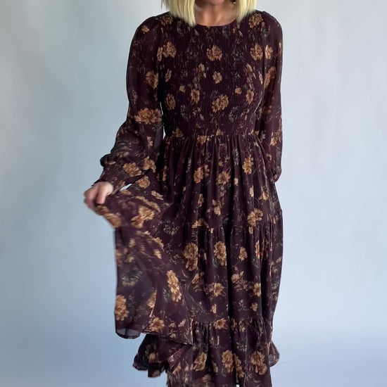 Evelyn Smocked Midi Dress in Dark Clove Floral with a smocked bodice, smocked cuffs, and a tiered midi skirt.