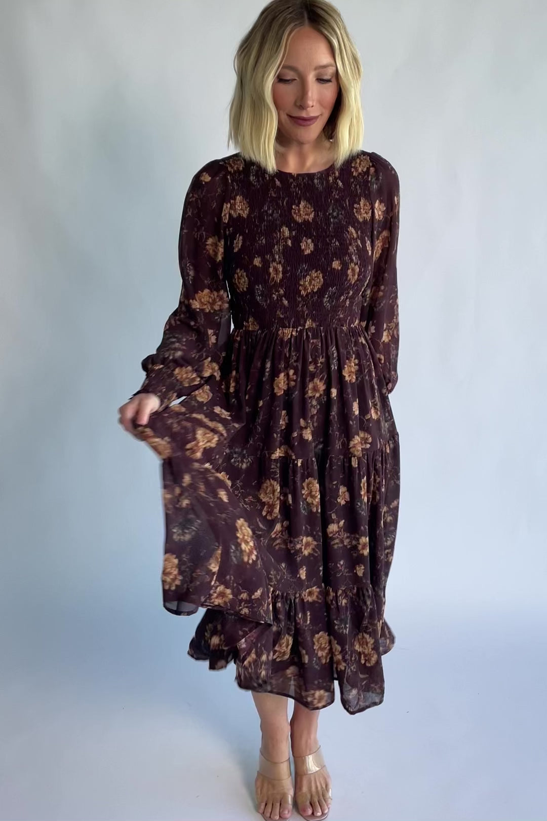 Evelyn Smocked Midi Dress in Dark Clove Floral with a smocked bodice, smocked cuffs, and a tiered midi skirt.