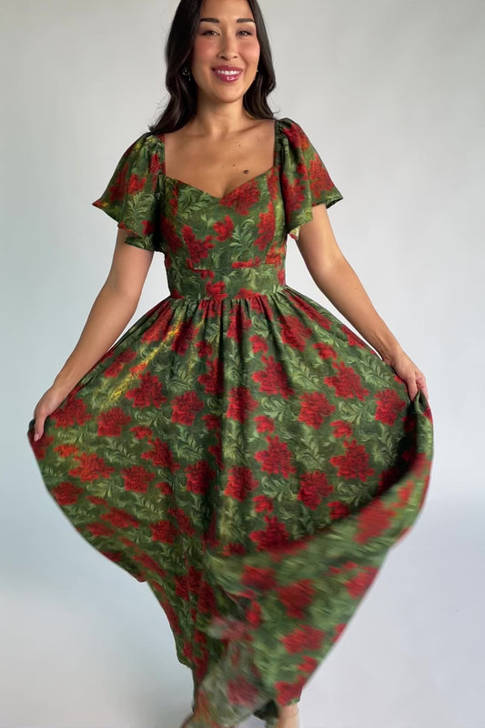 Astor Maxi Dress in Green + Red with floral print, sweetheart neckline, flutter sleeves, smocked back, and flowing skirt.