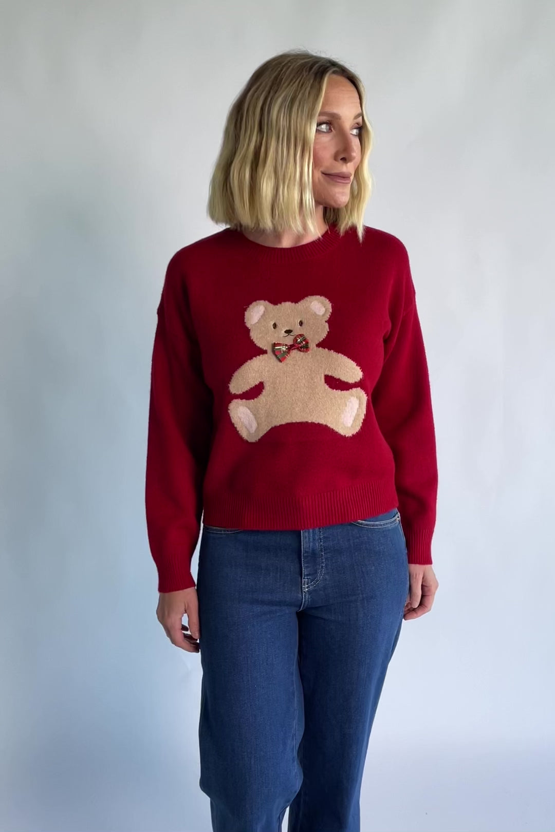 Jaxton Sweater in Red with a round neckline, ribbed trim, and a teddy bear graphic with a bow tie.