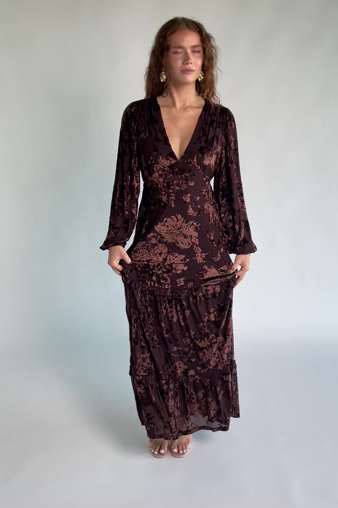 Liana Velvet Embossed Ruffle-Tier Maxi Dress in Brown with V-neck, long sleeves, elastic waist, and tiered skirt.