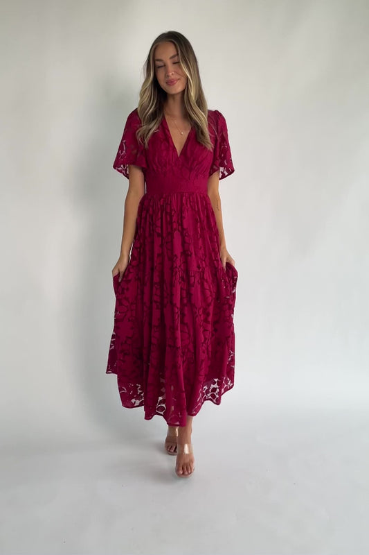 Floral lace midi dress with a deep V-neckline, short flutter sleeves, smocked back bodice, defined waistband, and tiered skirt.