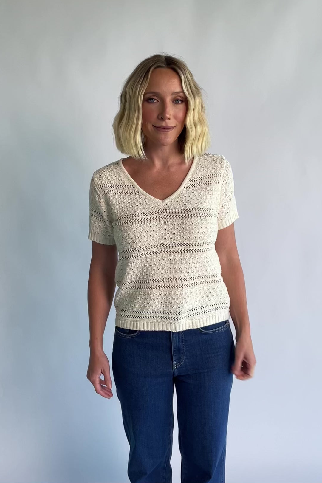 Albon Open Knit Top in Cream with V-neckline, open knit texture, and ribbed trim.