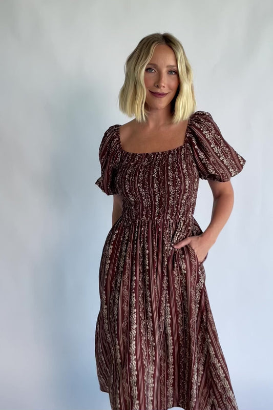 Keira Midi Dress in Mahogany Print with a square neckline, smocked bodice, and short puff sleeves.