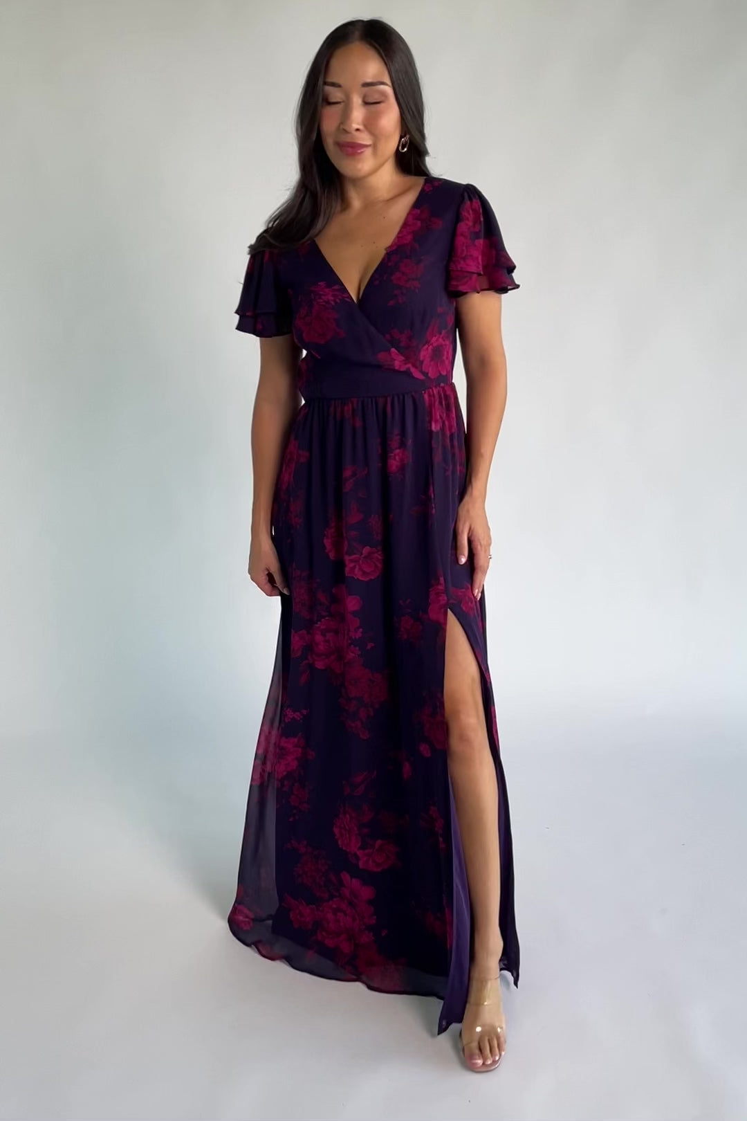 Theodora Maxi Dress in Indigo + Berry with floral print, crossover V-neck, flutter sleeves, elastic waist, and leg slit.