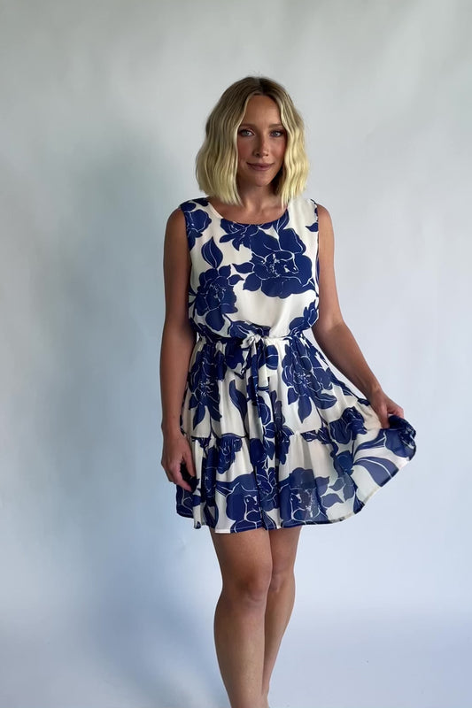 Alanya Short Dress in Off White + Blue Floral with round neckline, tank-style sleeves, and tiered skirt.